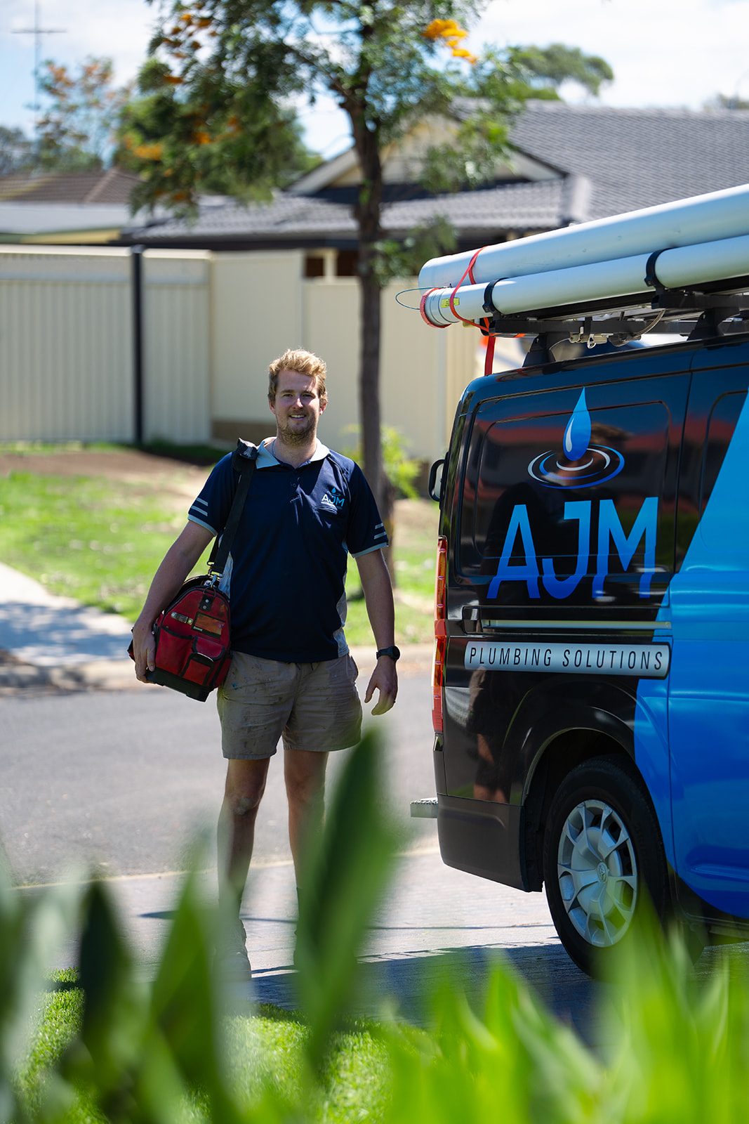Aaron walking past the AJM van with his tool bag