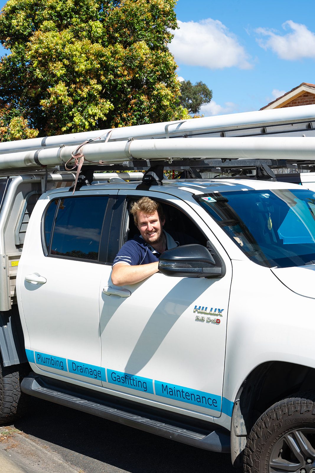 Aaron in the AJM ute window, on the way to a job