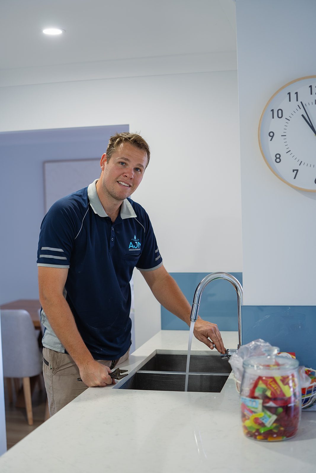 Aaron from AJM Plumbing Solutions testing a kitchen mixer tap
