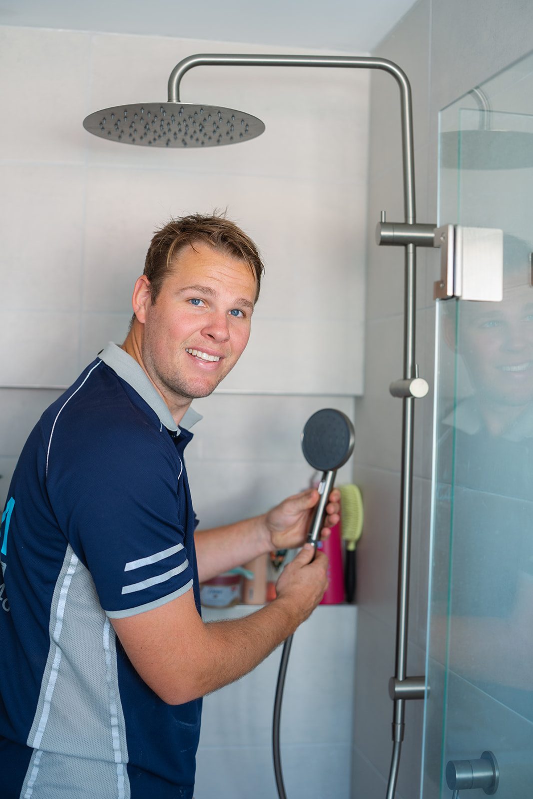 Aaron from AJM Plumbing Solutions fitting a shower rail