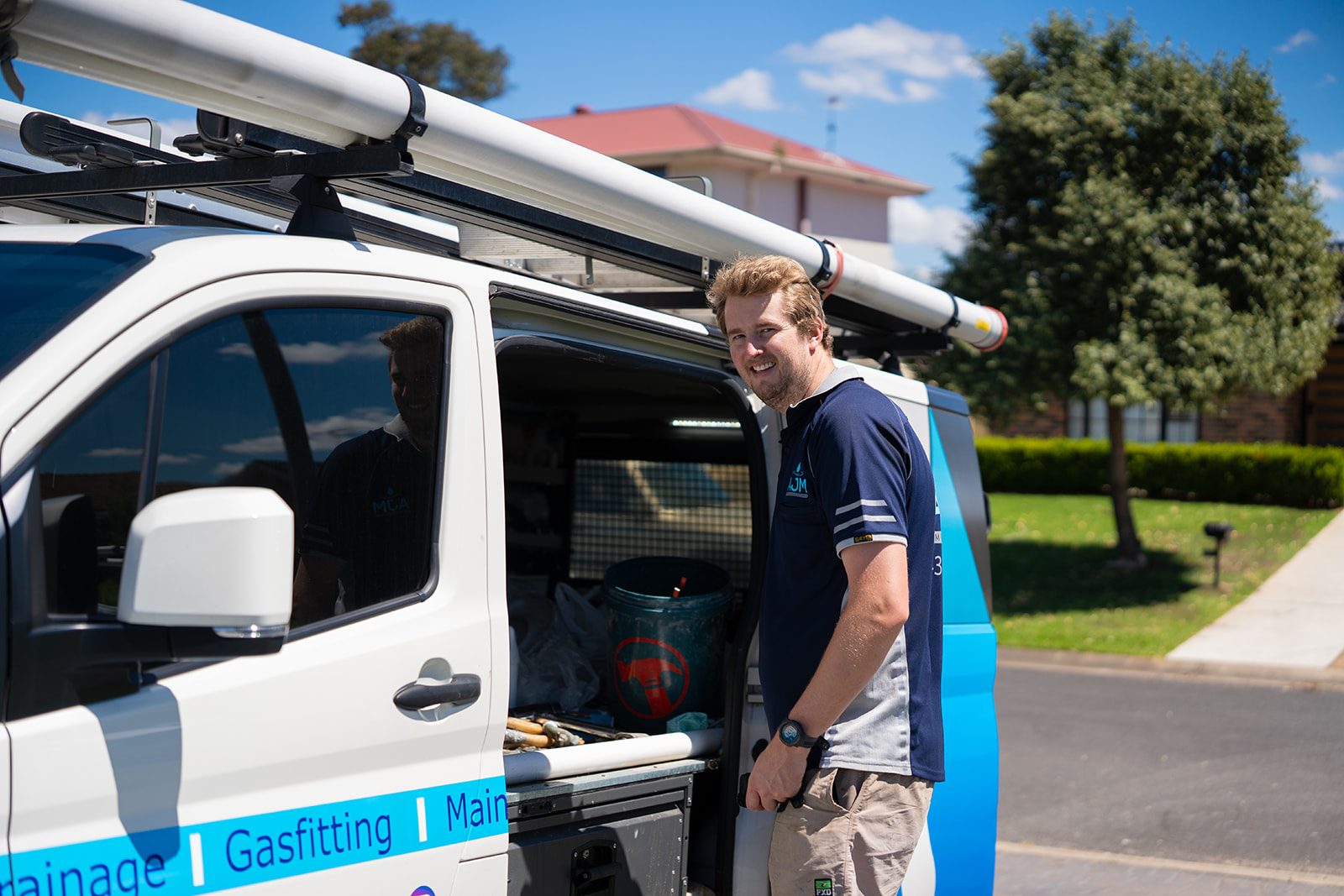 Aaron beside the AJM Plumbing Solutions van