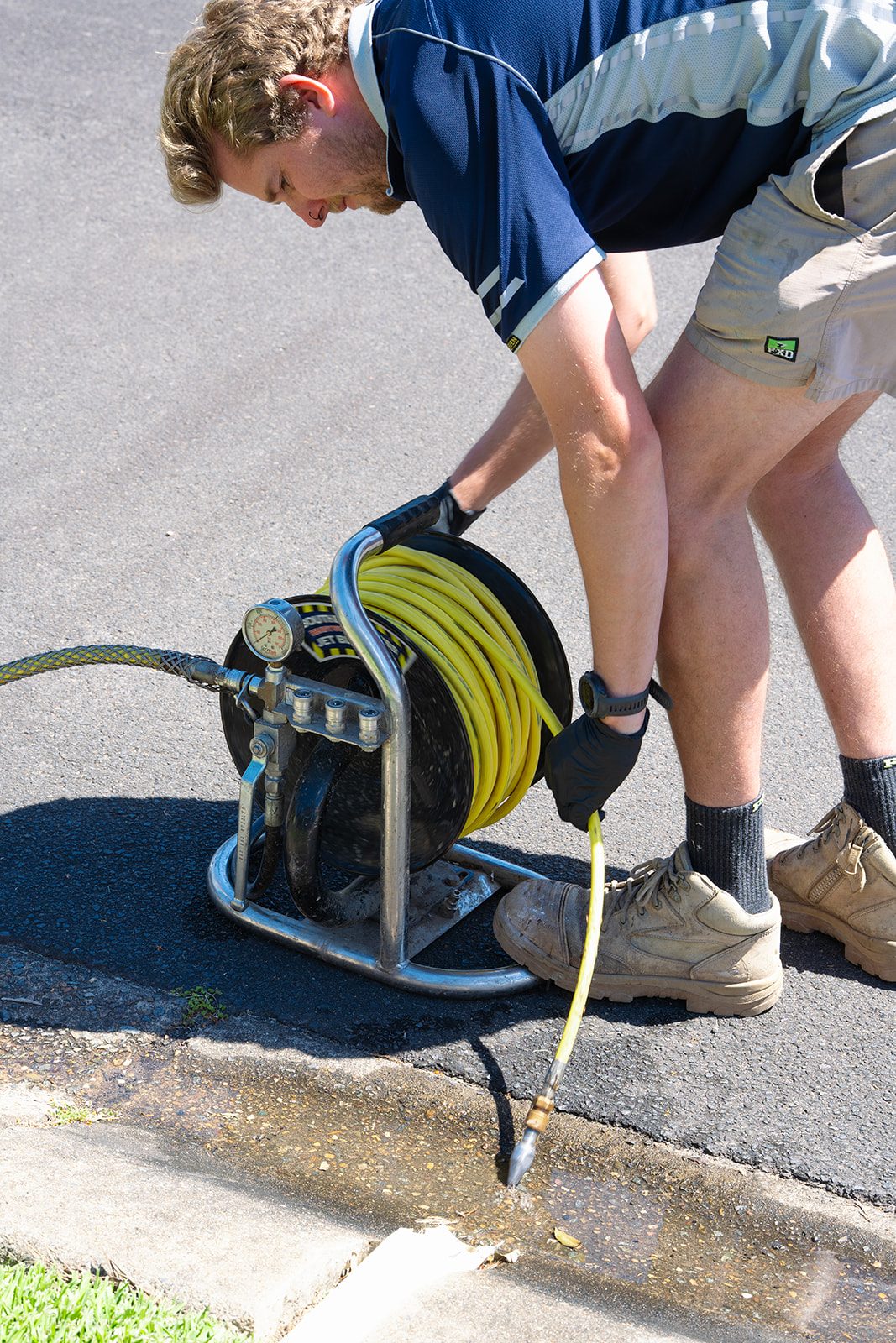 Aaron from AJM Plumbing Solutions feeding the drain jetter from the reel